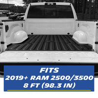 Real-world installation of a custom-fit black TPE heavy-duty truck bed mat inside a white 2019-2026 Ram 2500/3500 8 FT (98.3 in) bed. The image demonstrates the precise edge-to-edge fitment perfectly contouring the cargo space for comprehensive seamless protection.